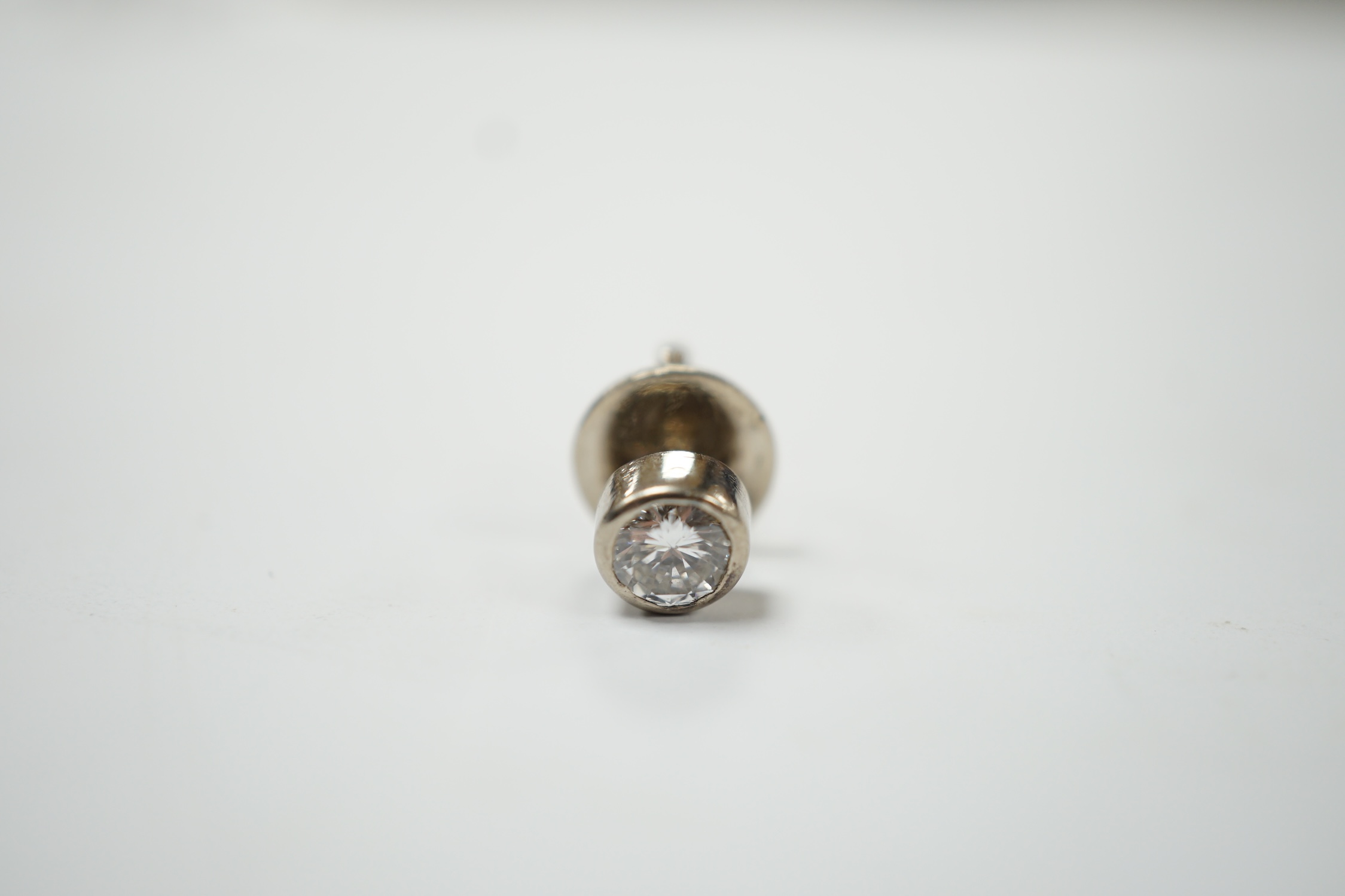 A white metal mounted solitaire diamond set tie stud, the stone measuring approximately 5mm in diameter, gross weight 1.6 grams. Good condition.